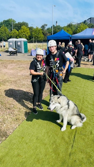 Young person with his Foster Care Key Worker in a field with a nice big dog